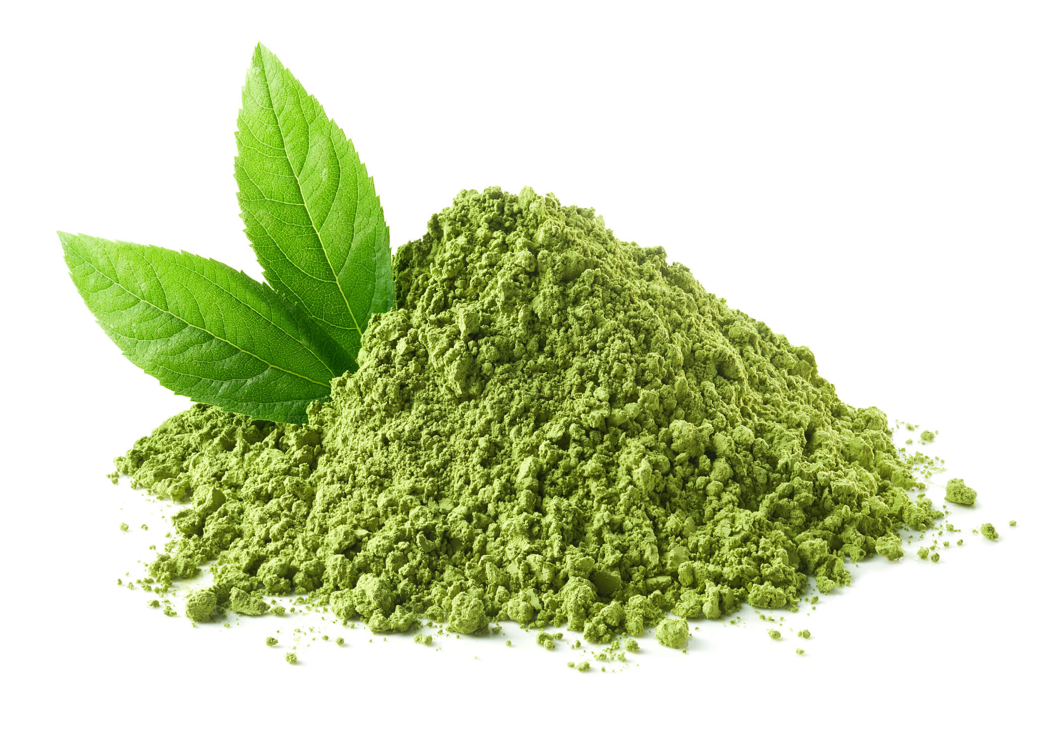 A pile of matcha made from green tea with two green tea leaves sticking out of the left side. This is set against a white background