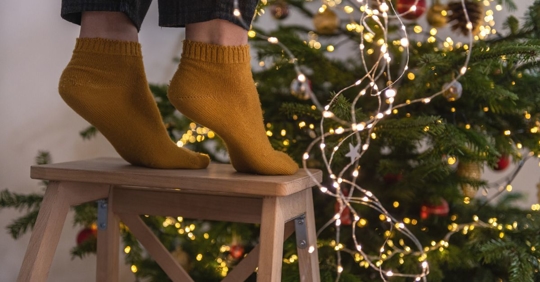Holiday accident waiting to happen while hanging lights on a Christmas tree; slip and fall.