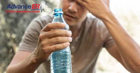 man holding bottle of water
