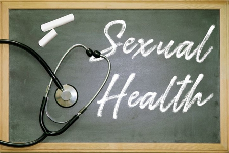 Blackboard with "Sexual Health" written on it and a stethoscope draped on top.