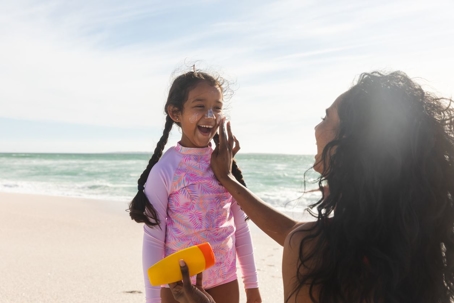 mom putting sunscreen on daughter
