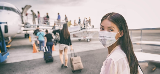 Girl with mask near airplane