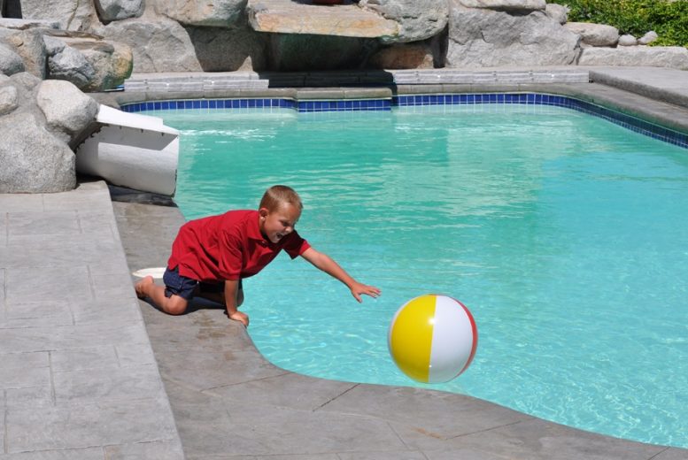 Young boy playing in a pool