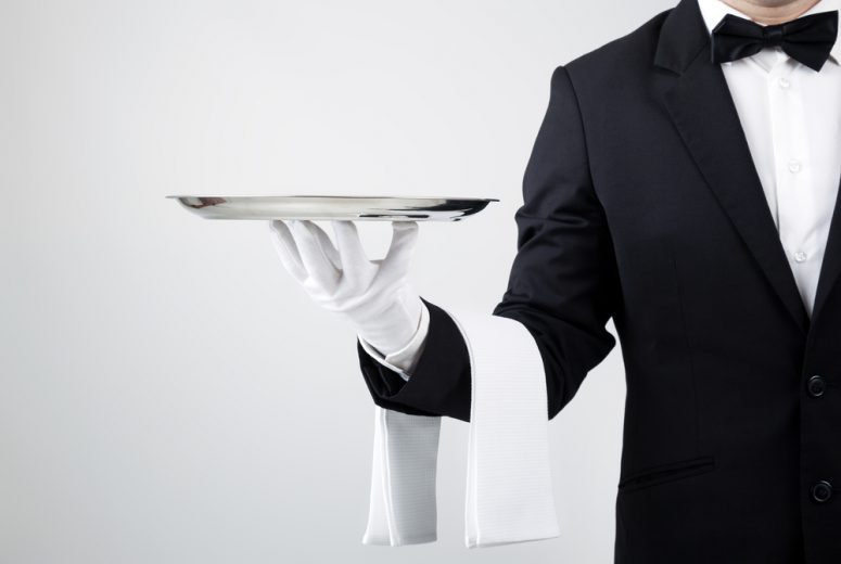 Butler holding serving tray